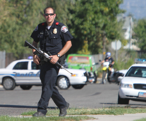 Rick Egan   |  The Salt Lake Tribune
West Valley City police take a position during a standoff with an armed man in the 4000 block of Ivana Street on Friday afternoon.