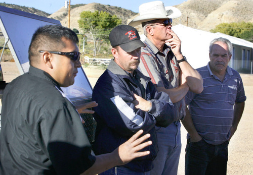 Scott Sommerdorf  l  The Salt Lake Tribune&#xA;Leallen Blackhair (left) of the Ute Tribe describes how he will organize his resources in the cleanup efforts as (from left to right) Mike Leflar (Duchesne County Emergency Response), Kent Petrus, and Ron Winerton County Commisioners listen. An illegal dumping of oil into the Strawberry River near near the Duchesne County Fairgrounds was being contained and cleaned up early Saturday morning, September 24, 2010.