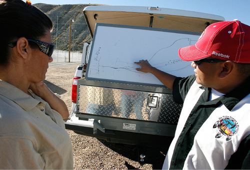 Scott Sommerdorf  l  The Salt Lake Tribune&#xA;Misty Burns of the Dept of Homeland Security (left) listens as Leallen Blackhair (cq) of the Ute Tribe explains on a map at the command post where the efforts to contain the oilspill are being made. An illegal dumping of oil into the Strawberry River near near the Duchesne County Fairgrounds was being contained and cleaned up early Saturday morning, September 24, 2010.