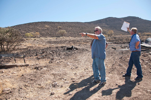 Michael Mangum  |  The Salt Lake Tribune&#xA;&#xA;Val Johnson, left, and insurance adjuster Glenn Johnson, right, survey the damage to Val Johnsons property in Herriman on Saturday, September 25, 2010 after the Machine Gun fire destroyed his home earlier in the week.