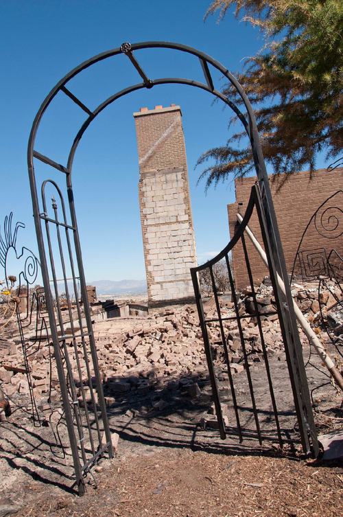 Michael Mangum  |  The Salt Lake Tribune&#xA;&#xA;The chimney and part of two exterior walls are all that stand of Val Johnsons home on Saturday, September 25, 2010. The Machine Gun fire destroyed Johnsons home in Herriman.