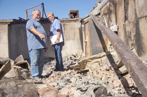 Michael Mangum  |  The Salt Lake Tribune&#xA;&#xA;Val Johnson, left, examines the rubble of his home for belongings with friend and insurance adjuster Glenn Johnson on Saturday, September 25, 2010. Johnson lost his him to the Machine Gun fire earlier in the week.