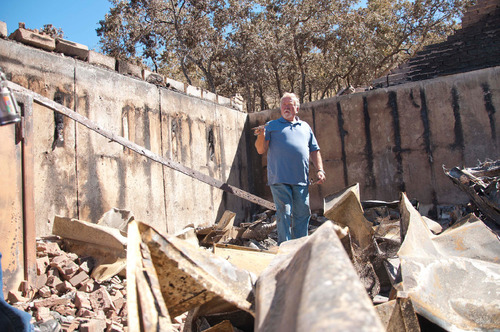 Michael Mangum  |  The Salt Lake Tribune&#xA;&#xA;Val Johnson examines the rubble of his home for belongings on Saturday, September 25, 2010. Johnson lost his home to the Machine Gun fire earlier in the week.