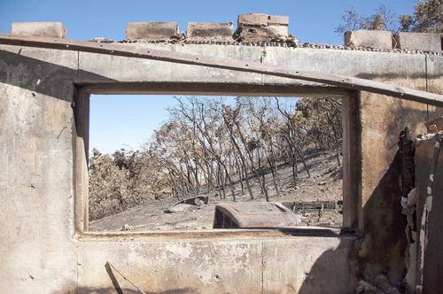 Michael Mangum  |  The Salt Lake Tribune&#xA;&#xA;Damage to the home and property of Val Johnson is seen out of what once was the basement window of Johnsons home in Herriman on Saturday, September 25, 2010. Johnson lost his home to the Machine Gun fire earlier in the week.