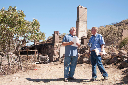 Michael Mangum  |  The Salt Lake Tribune

Val Johnson, left, discusses insurance paperwork with friend and insurance adjuster Glenn Johnson after having rummaged through the remains of Val Johnsons home in Herriman on Saturday, September 25, 2010. Johnson lost his home to the Machine Gun fire earlier in the week.