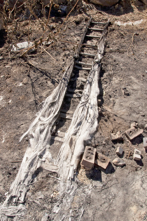 Michael Mangum  |  The Salt Lake Tribune&#xA;&#xA;The remains of a ladder lie on Val Johnsons property in Herriman on Saturday, September 25, 2010. Johnson lost his home and many other possessions to the Machine Gun fire earlier in the week.