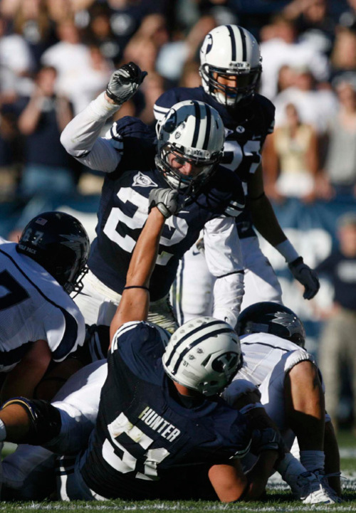 Trent Nelson  |  The Salt Lake Tribune&#xA;BYU defensive back Andrew Rich (22, top) and BYU linebacker Shane Hunter (51) celebrate a 4th down stop during the second quarter, BYU vs. Nevada, college football Saturday, September 25, 2010 at LaVell Edwards Stadium in Provo.