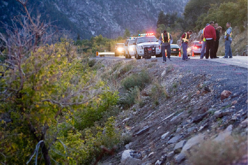 Djamila Grossman  |  The Salt Lake Tribune
Law enforcement officials investigate the scene of a car crash Sunday in Little Cottonwood Canyon. The car went off the road and down a 100-foot embankment. Two men were injured.