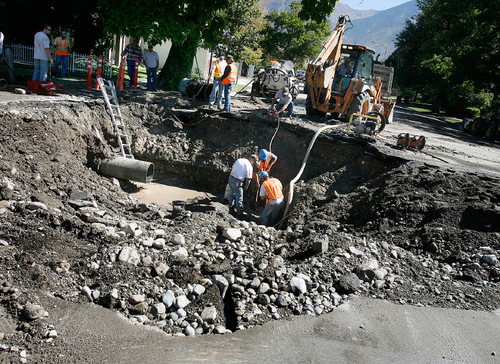 Scott Sommerdorf  l  The Salt Lake Tribune&#xA;A crew works to replace a section of water main that broke early Monday morning at the intersection of 600 West and 300 South, Monday, September 27, 2010. An apartment building at 339 South was one of the buildings whose basements flooded.