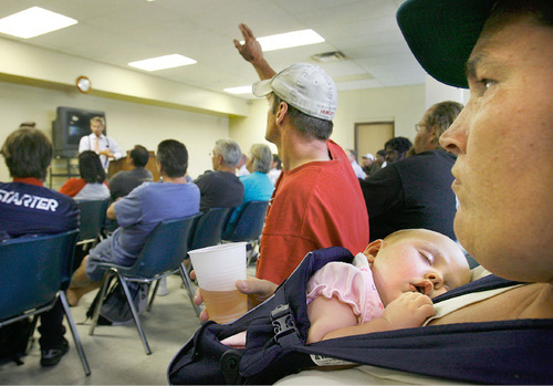 SCOTT SOMMERDORF  l  The Salt Lake Tribune&#xA;Carl Dowling raises his hand to ask Mayor Ralph Becker a question as his wife Jennifer and four month-old baby Brienna sit beside him. The Dowlings came here recently from Kansas. Becker conducted a town hall Monday at the Bishop Weigand Homeless Resource Center in Salt Lake City.
