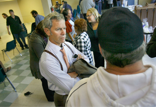 SCOTT SOMMERDORF  l  The Salt Lake Tribune
Mayor Ralph Becker speaks to a homeless man after a town hall meeting Monday at the Bishop Weigand Homeless Resource Center in Salt Lake City.