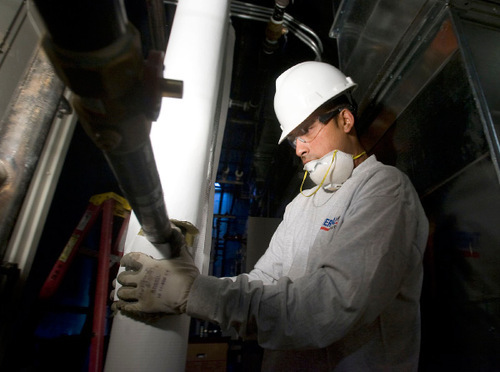 Al Hartmann  |  The Salt Lake Tribune
Taylorsville resident Javier Mendez fits insulation around a pipe at the soon-to-open Sorensen Recreation Center in Herriman. Mendez was hired by Thermal West after he informed the company of a Utah Department of Workforce Services program -- 