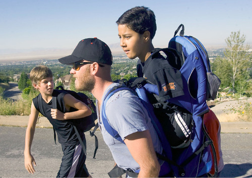 Al Hartmann  |  The Salt Lake Tribune
Gabe Adams, 11,  who does not have arms or legs, joined fellow sixth-graders from Kaysville Elementary on Thursday to hike Adams Canyon above Layton to learn about nature and conduct science experiments. His older brother, Brennan Adams, carried Gabe in a backpack on the hike. Gabe's brother, Landon, left, also a sixth grader, hikes alongside as they leave the last of the city behind and enter the canyon.