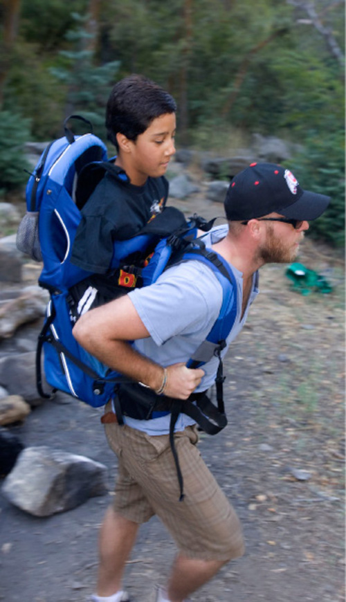 Al Hartmann  |  The Salt Lake Tribune
Gabe Adams, 11,  who does not have arms or legs, joins fellow sixth-graders from Kaysville Elementary to hike Adams Canyon above Layton to learn about nature and conduct science experiments along the way.   His older brother Brennan Adams carries Gabe in a backpack on the hike.