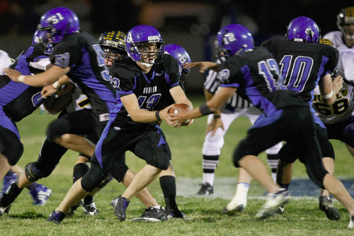 Chris Detrick  |  The Salt Lake Tribune &#xA;Beaver's Ty Yardley #13 hands off to Slade Edwards #10 during the first half of the game at Beaver High School Friday October 1, 2010.