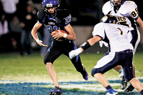 Chris Detrick  |  The Salt Lake Tribune &#xA;Beaver's Adam Kia #22 runs the ball past Enterprise's Jade Hulet #1 during the second half of the game at Beaver High School Friday October 1, 2010.