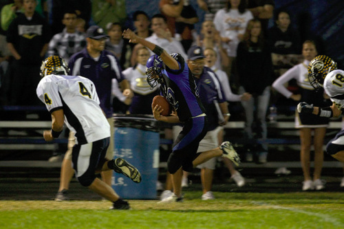 Chris Detrick  |  The Salt Lake Tribune &#xA;Beaver's Anthony Gibson #12 runs around Enterprise's Slade Moyle #4 during the first half of the game at Beaver High School Friday October 1, 2010.