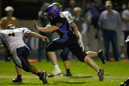 Chris Detrick  |  The Salt Lake Tribune &#xA;Beaver's Slade Edwards #10 runs past Enterprise's Slade Moyle #4 during the second half of the game at Beaver High School Friday October 1, 2010.