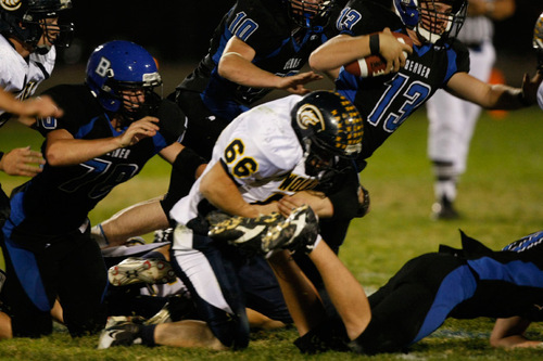 Chris Detrick  |  The Salt Lake Tribune &#xA;Enterprise's Ross Taylor #66 tackles Beaver's Ty Yardley #13 during the first half of the game at Beaver High School Friday October 1, 2010.