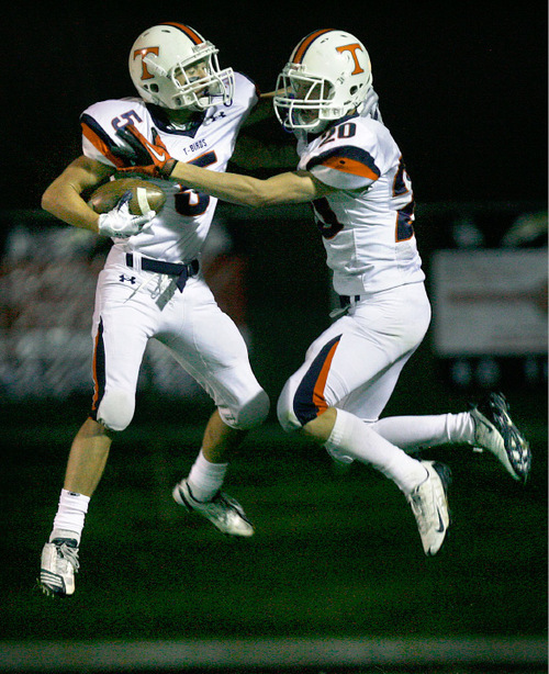 Scott Sommerdorf  l  The Salt Lake Tribune&#xA;Timpview WR Josh Warner (5) leaps in the end zone with team mate Rickey Shumway (20) after Warner scored a TD to give Timpview their 23-13 lead at the half at Westlake, Friday 10/1/2010.