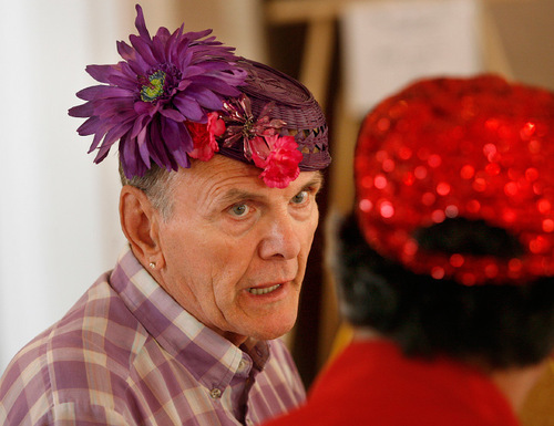 Scott Sommerdorf  l  The Salt Lake Tribune
Gene Patten (left), a hat maker, created his own flowery purple hat for SAGE Utah's 