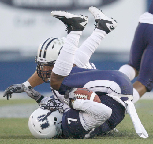 Trent Nelson  |  The Salt Lake Tribune&#xA;Utah State's Chris Randle rolls to a stop after intercepting a pass from BYU quarterback Jake Heaps. Utah State vs. BYU college football in Logan Friday, October 1, 2010.