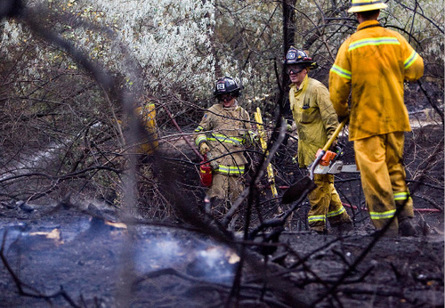 Djamila Grossman  |  The Salt Lake Tribune&#xA;&#xA;Firefighters spray down burnt trees and shrubs after a fire broke out at Wheeler Historic Farm in Murray, Sunday, Oct. 3, 2010.