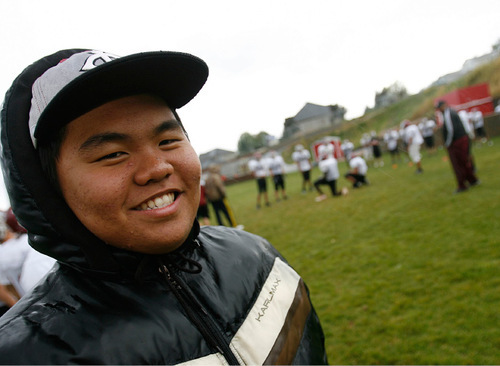 Scott Sommerdorf  l  The Salt Lake Tribune
Injured Layton Christian Academy player Fung Kim from South Korea watches practice Oct. 4 in Layton. The small school's football team has 10 players from foreign countries, many just learning the game.
