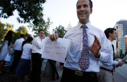 Francisco Kjolseth  |  The Salt Lake Tribune&#xA;Seth McCarthy of Orange County, CA., wears a knit tie made by a missionary sister as he hold a sign that reads 