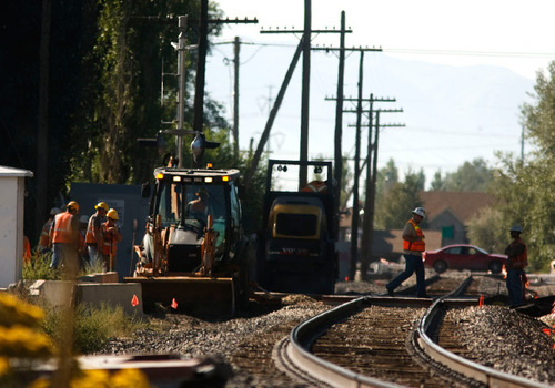 Leah Hogsten  |  The Salt Lake Tribune&#xA;  UTA contractors are laying the new FrontRunner South commuter rail lines Wednesday, Sept.29, 2010, in Lehi across the intersection of 400 West and Main Street. Union Pacific workers are improving adjacent rails at the same time.