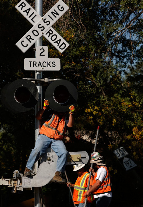 Leah Hogsten  |  The Salt Lake Tribune Union Pacific's Russell Evans repositions railroad crossing lights at the FrontRunner South and Union Pacific rail lines at 400 West and Main in Lehi.