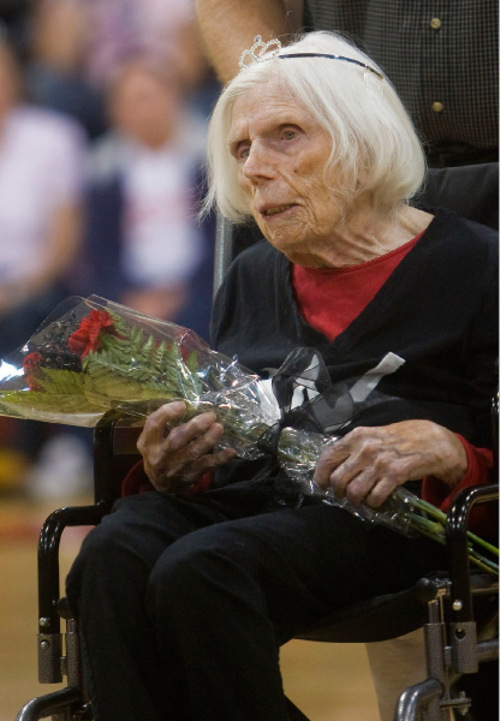 Al Hartmann  |  Salt Lake Tribune
104-year-old Lillian Draper, who is believed to be West High School's  oldest living alumnus receives a boquet of roses.  She later lead students in and old fight song from her days at the school during a homecoming assembly Thursday October 7th.