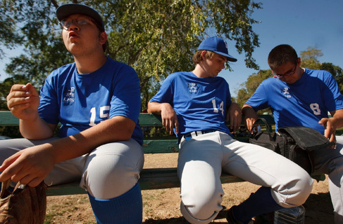 Leah Hogsten  |  The Salt Lake Tribune 
l-r 15 -- Kyle Rudy reacts to game action as  Zack Welch and #8 ???? chat on the bench. The Salt Lake Lutheran baseball team during their last game of the season Friday, October 1, 2010, in SLC at Lindsay Gardens. The Salt Lake Lutheran baseball team, a collection of rookies that make up a varsity squad, has struggled in another lousy season. In their opener against Tabiona, the Lynx lost 39-2. But this is a team of kids who play baseball merely so there could be a baseball team at Salt Lake Lutheran.