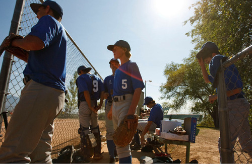 Leah Hogsten  |  The Salt Lake Tribune 
5 -- Dane Dickerson (center) and his teammates head back out on the field. The Salt Lake Lutheran baseball team during their last game of the season Friday, October 1, 2010, in SLC at Lindsay Gardens. The Salt Lake Lutheran baseball team, a collection of rookies that make up a varsity squad, has struggled in another lousy season. In their opener against Tabiona, the Lynx lost 39-2. But this is a team of kids who play baseball merely so there could be a baseball team at Salt Lake Lutheran.