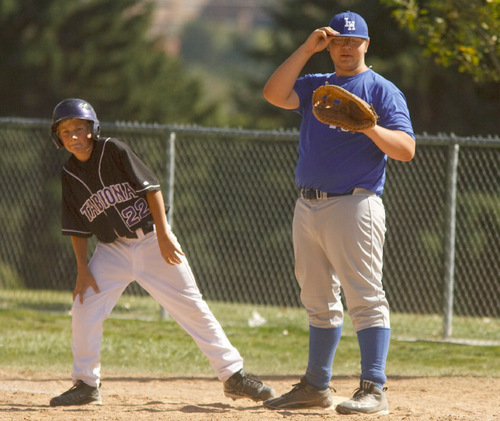 Leah Hogsten  |  The Salt Lake Tribune 
15 -- Kyle Rudy, first baseman (right). The Salt Lake Lutheran baseball team during their last game of the season Friday, October 1, 2010, in SLC at Lindsay Gardens. The Salt Lake Lutheran baseball team, a collection of rookies that make up a varsity squad, has struggled in another lousy season. In their opener against Tabiona, the Lynx lost 39-2. But this is a team of kids who play baseball merely so there could be a baseball team at Salt Lake Lutheran.