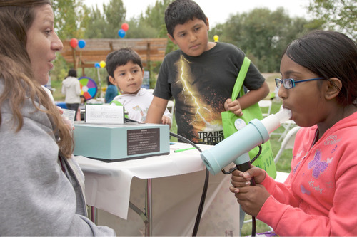 Michael Mangum  |  The Salt Lake Tribune
Nicky Garcia of Intermountain Allergy & Asthma administers a test to Inakhshmi Rashid, 10, of Rose Park, while Adrian Higuera, 5, back left, and Alejandro Higuera, 10, back right, of Rose Park, watch during a health fair held at Day-Riverside Library in Salt Lake City on Saturday, October 9, 2010. The health fair was was intended to raise awareness of potential environmental health issues in the Rose Park and Glendale areas of Salt Lake.
