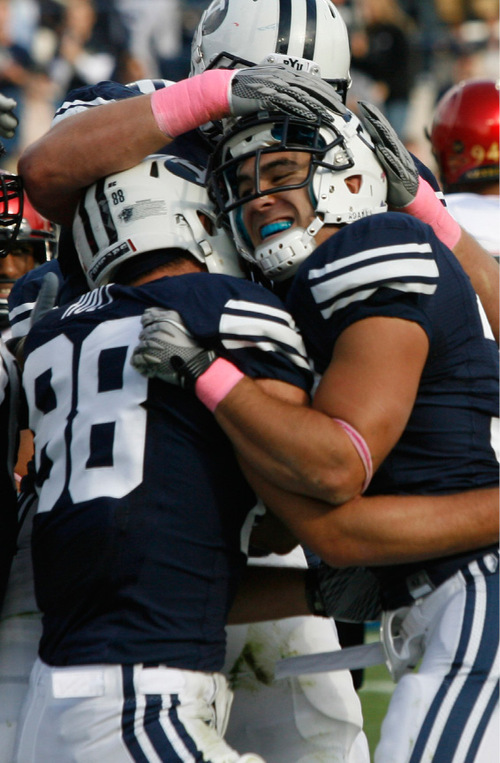 Rick Egan   |  The Salt Lake Tribune&#xA;&#xA;BYU teamates mob Bryan Kariya after he scored a touchdown for the Cougars, in football action, BYU vs. San Diego State, at Lavell Edwards Stadium in Provo,  Saturday, October 9, 2010