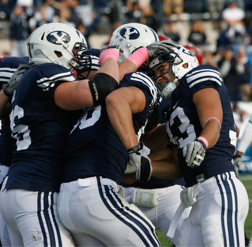 Rick Egan   |  The Salt Lake Tribune&#xA;&#xA;BYU teamates mob Bryan HKariya after he scored a touchdown for the Cougars, in football action, BYU vs. San Diego State, at Lavell Edwards Stadium in Provo,  Saturday, October 9, 2010