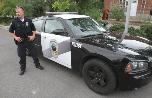 Rick Egan   |  The Salt Lake Tribune&#xA;&#xA; Midvale police officer Aaron Upwall with his patrol car in front of the Midvale Police Department. Murray and Midvale both had increases in crime in 2009.
