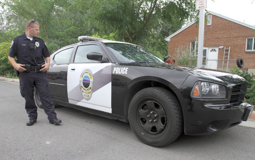 Rick Egan   |  The Salt Lake Tribune&#xA;&#xA; Midvale police officer Aaron Upwall with his patrol car in front of the Midvale Police Department. Murray and Midvale both had increases in crime in 2009.