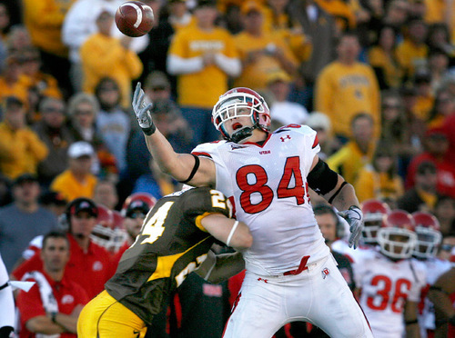 Scott Sommerdorf  l  The Salt Lake Tribune&#xA;Wyoming Cowboys safety Chris Prosinski (24) lays a hit on Utah Utes tight end Brad Clifford (84) to dislodge the ball and prevent a catch during first half play. The Utah Utes held a 23-0 halftime lead at Wyoming, Saturday 10/16/2010.