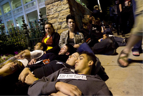 Djamila Grossman  |  The Salt Lake Tribune&#xA;&#xA;A group of people join hundreds of others in laying down on the pavement, forming a chain around Temple Square in Salt Lake City, Thursday, Oct. 7, 2010. Supporters of the lesbian, gay, bisexual and transgender (LGBT) community protested recent remarks by LDS apostle Boyd K. Packer that same-sex attraction is 