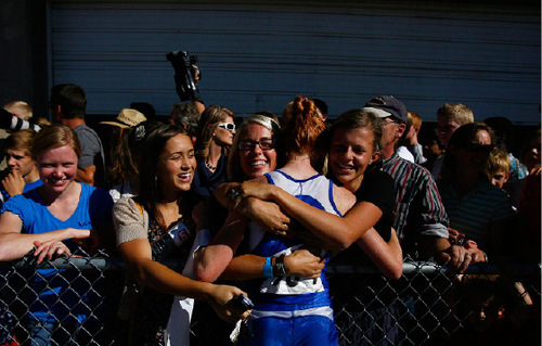 Djamila Grossman  |  The Salt Lake Tribune&#xA;&#xA;A group of people hug Orem High School's Summer Harper, 654, after she won the 4A girls race at the 2010 Utah UHSAA State Cross Country Championships at Sugarhouse Park in Salt Lake City, Wednesday, Oct., 20, 2010.