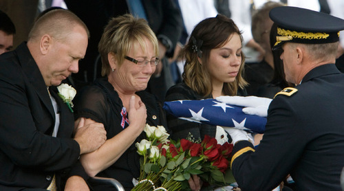 Steve Griffin  |  The Salt Lake Tribune

Roberta Pitt weeps as she is given an American Flag during funeral services for her son, Jordan Byrd,  who was killed in Afghanistan last week. Pitt is consoled by her husband Scott Pitt. Byrd's wife, Savanna Byrd,  is at right,  during services at the Grantsville City Cemetery Friday, October 22, 2010.