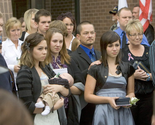 Steve Griffin  |  The Salt Lake Tribune&#xA;&#xA;Jordan Byrd's wife, Savanna Byrd,  holds their one-month-old child Ayden, as his casket is placed in a hearse following services at  the Tooele South Stake Center Friday, October 22, 2010. Byrd was killed in Afghanistan last week. Byrd's sister Abby Byrd, third from right, his father Justin Brost, center, and mother Roberta Pitt far right also watch as the casket is delivered to the hearse.