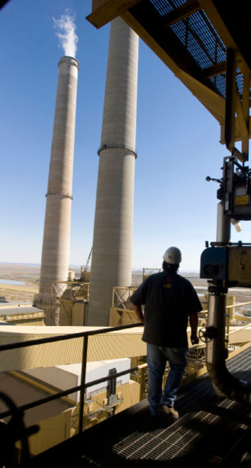 Al Hartmann  |  The Salt Lake Tribune&#xA;Gary Haeck, 40, a mechanic supervisor at the Hunter 2 coal-fired power plant in Castle Dale, looks out at the smoke stacks from the 14th floor of the coal-fired facility whose stable, high-paying jobs have helped bolster Emery County's economy through the roughest recession in decades. Besides the power plant jobs, generating electricity also drives mining, trucking and service support industries in both Emery and Carbon counties.