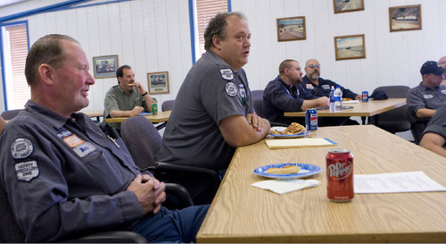 Al Hartmann  |  The Salt Lake Tribune&#xA;Savage coal truck drivers Mark Lofgreen, 63, of Carbonville, left,  and Clint McInelly, 44, center, of Wellington, attend a company safety training luncheon in Price. Truck driving jobs in the coal industry of Carbon and Emery counties pay well and are stable, helping prop up the economy of Utah's 