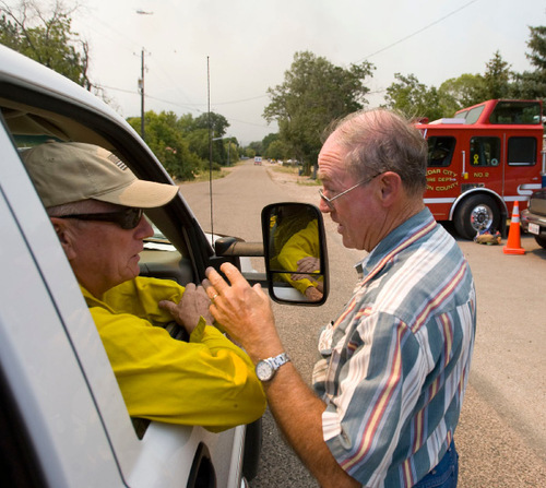 Mill Flat Fire near New Harmony.  Wasington County Sheriff Kirk Smith, left, stops to talk with New Harmony Mayor Joel Webster before going into the damaged fire zone for a look at burned out and damaged properties.  Home owners were allowed back to their properties Monday.   Al Hartmann/The Salt Lake Tribune   8/31/2009