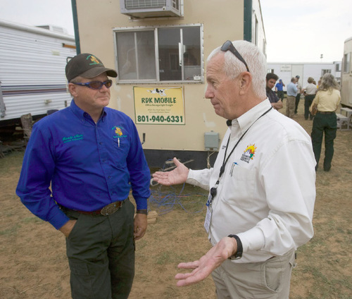 Al Hartmann/The Salt Lake Tribune&#xA;Rowdy Muir, incident commander for the Mill Flat fire, left,  listens to Kirk Smith, Washington County Sheriff at the fire incident commad center in new Harmony on Tuesday.