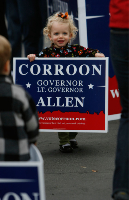 Francisco Kjolseth  |  The Salt Lake Tribune&#xA;Kate Dunn, 2, gets creative with a campaign sign as Peter Corroon kicks off his 29-county bus tour, sort of his last push to the election with a rally in Salt Lake City at the corner of 200 East, 2100 South on Saturday, Oct. 23, 2010.&#xA;Salt Lake City, Oct. 23, 2010.